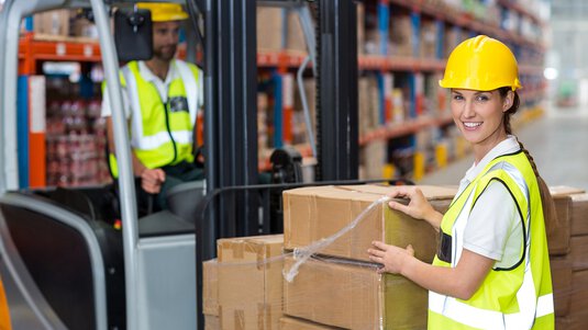 Warehouse employees unloading packages